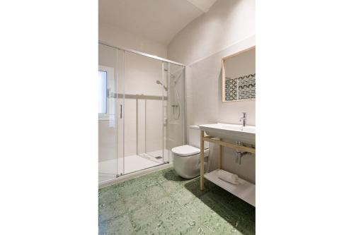 a bathroom with a toilet and a sink and a shower at Casa Boixader in Navás