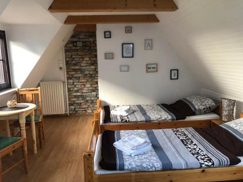 a room with two bunk beds in a attic at Ferienwohnung 2 Basthorst in Basthorst