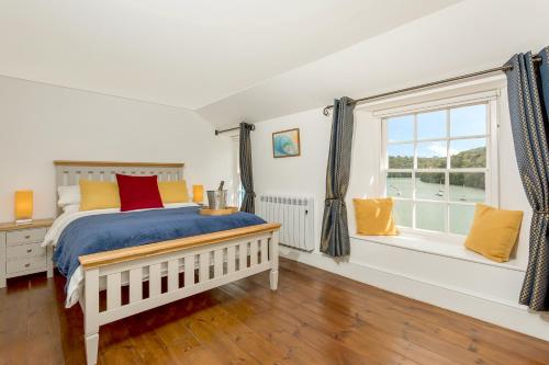 a bedroom with a bed and a window at Fal River Cottage in Truro