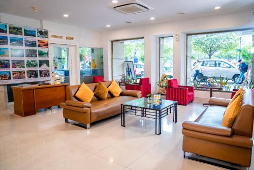 eine Lobby mit Sofas und einem Tisch in einem Laden in der Unterkunft Oscar Saigon Hotel in Ho-Chi-Minh-Stadt