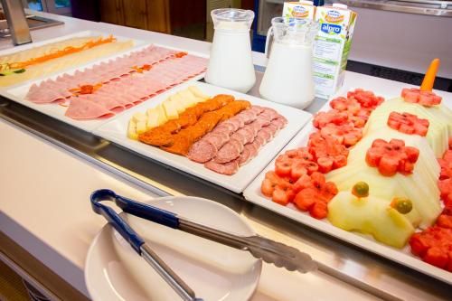 a buffet of different types of food on a table at Apartamentos Maribel in Cala Blanca