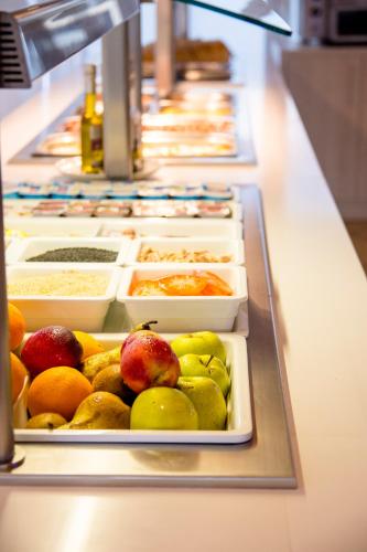 a buffet line with many different types of food at Apartamentos Maribel in Cala Blanca
