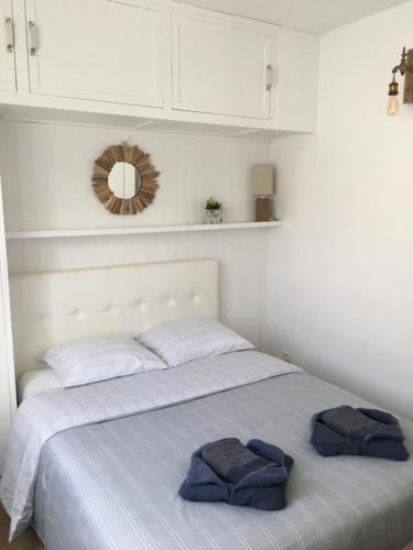 a bedroom with a bed with two towels on it at Villa L'Amiraute in Agde