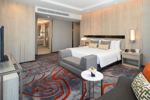 a hotel room with a bed and a couch at Hotel Nikko Bangkok in Bangkok