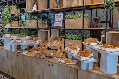a bakery with a display of bread and pastries at Somerset Greenways Chennai in Chennai