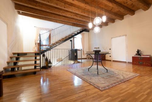 an empty room with a table and a staircase at AGRITURISMO LA CAMPAGNOLA in Montegaldella