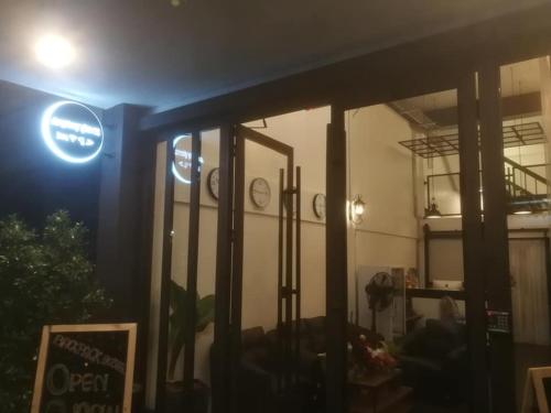 a view of a restaurant at night with a sign on the window at Backpack Hostel in Chiang Rai