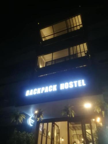 a sign on the front of a harrar hotel at night at Backpack Hostel in Chiang Rai