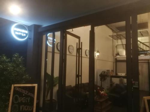 a room with a sign on the side of a building at Backpack Hostel in Chiang Rai
