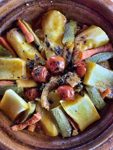 a brown bowl of food with vegetables in it at Kasbah Oulad Othmane in Agoubt