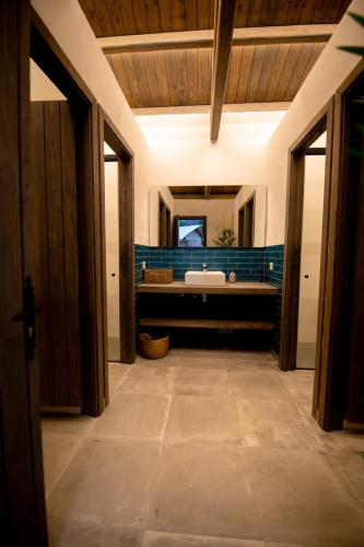 a bathroom with a tub and a sink and a mirror at Glamping Can Bora Lodges in Las Serras