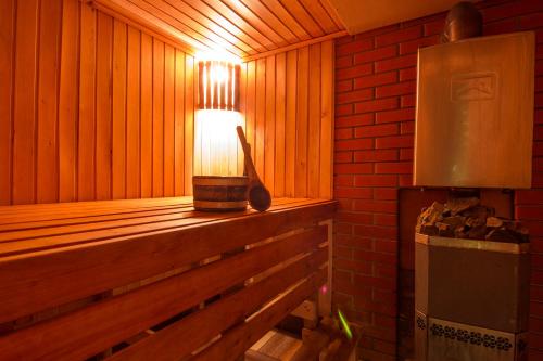a wooden sauna with a light on the ledge at Дом с сауной и басейном на Теремках in Hatne