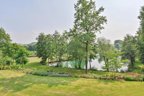 a park with a river and trees and a pond at De Gouden Forel in Gulpen