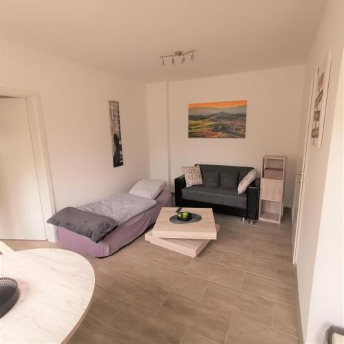 a living room with a couch and a table at Apartment außen Pfui innen Hui in Mönchengladbach