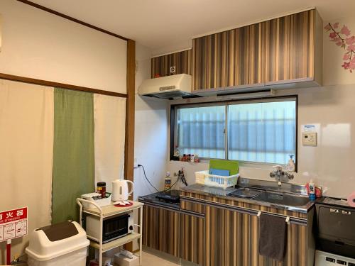 a small kitchen with a sink and a toilet at Kamata Ann in Tokyo