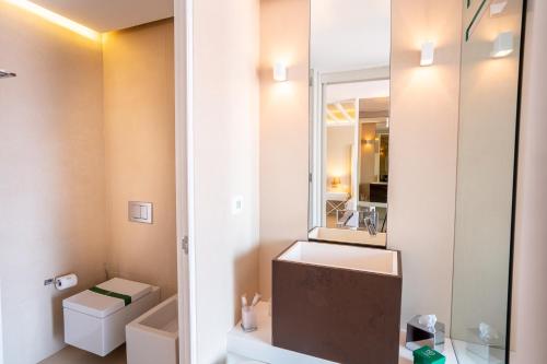 a bathroom with a sink and a mirror at Covo dei Saraceni in Polignano a Mare