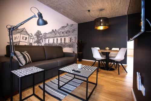 a living room with a couch and a table at Postcard City Apartments in Maribor