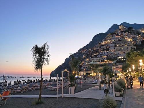 a view of a beach with a mountain at La Caravella di Positano - Relais, Beach & Residences in Positano