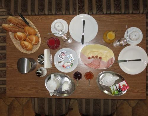 a table with plates and dishes on top of it at Pension Lang in St. Andrä am Zicksee