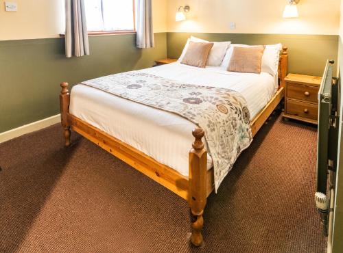 a bedroom with a large bed in a room at The Half Moon Inn and Country lodge in Yeovil