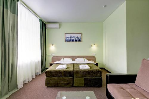 Кровать или кровати в номере Гостиничный Комплекс Тан