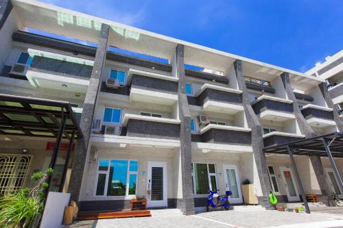 a large apartment building with blue windows at Fun Homestay in Jian