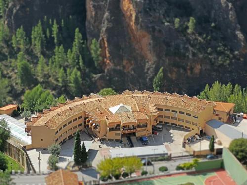 a model of a building with a mountain in the background at Hotel Restaurante Felipe II in Ayna