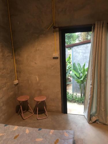 a room with two stools in front of a window at BeachBox@Koh Сhang in Ko Chang