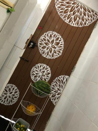 a wooden door with four white umbrellas on it at Hostel das Canárias in Natal