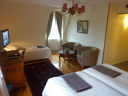 Postel nebo postele na pokoji v ubytování Nya Pallas Hotel