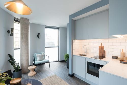 a kitchen with a sink and a counter at ARK Canary Wharf in London