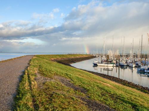 a rainbow over a marina with boats in the water at Holiday Home Ganuenta-1 by Interhome in Colijnsplaat