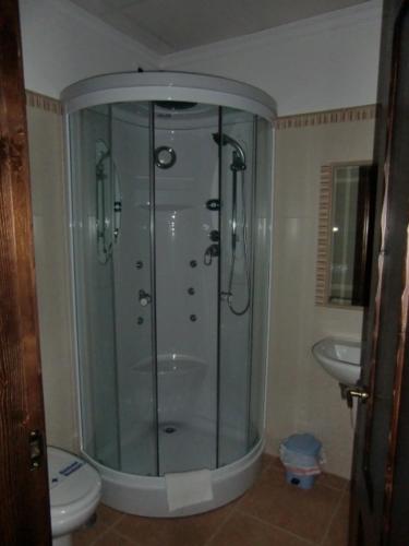 a shower in a bathroom with a toilet and a sink at O Lar da Avoa in Cambados