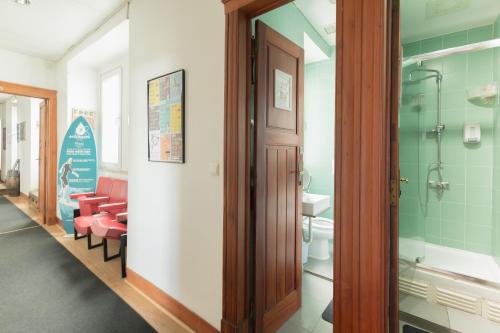 a bathroom with a shower and a toilet at Sunset Destination Hostel in Lisbon