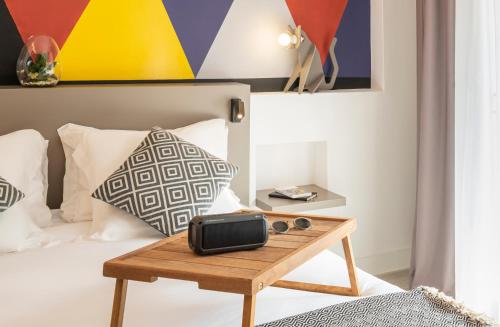 a bedroom with a bed with a wooden table at Aparthotel Adagio Rome Vatican in Rome