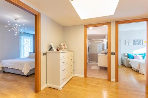 a bedroom with a bed and a dresser and a mirror at Teatro Nuovo Apartment with Free Parking in Udine