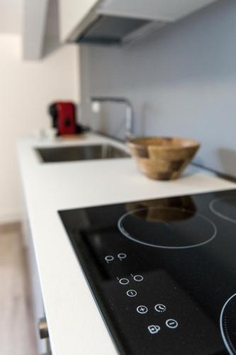 a kitchen with a stove with a bowl on a counter at Paduina3 Comfort Apartments in Trieste