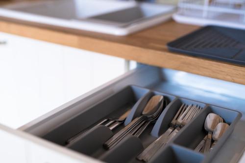 a drawer filled with utensils on a kitchen counter at Bohemian Antique Guesthouse in Odeceixe