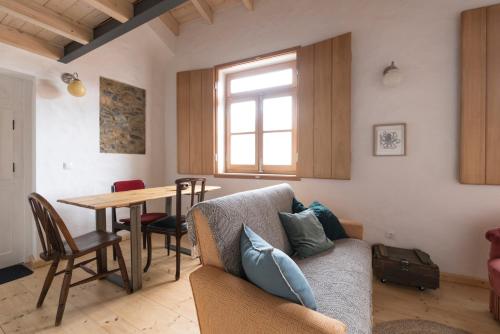 a living room with a couch and a table at Bohemian Antique Guesthouse in Odeceixe
