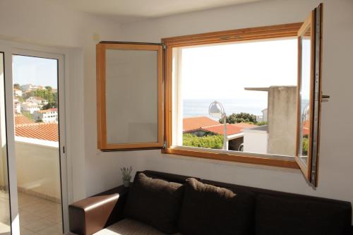 a living room with a couch and a window at Villa Korculaholidays in Zavalatica