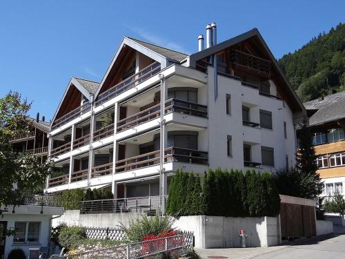 un grande edificio bianco con balconi sul lato di Apartment Seelenmattli by Interhome a Engelberg