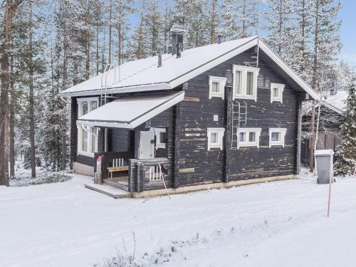 a log cabin in the snow with snow on the ground at Holiday Home Uuvana by Interhome in Äkäslompolo