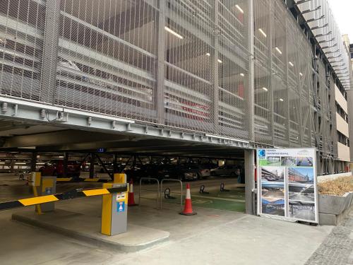 a large building with a parking garage in front of it at Moment Boutique Apartments in Belgrade