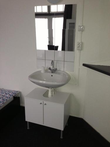 a bathroom with a sink and a mirror at Budgethotel de Zwaan in Eindhoven