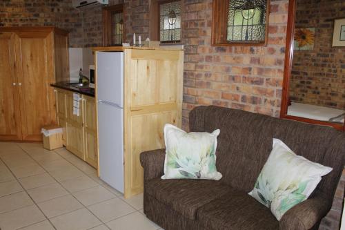 a couch with two pillows on it in a kitchen at IRONWOOD LODGE in Pennington