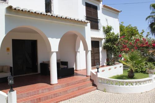 a white house with a white patio door at Villa Alcaide in Portimão