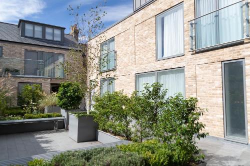 a brick building with plants in front of it at Citystay Living - Midsummer Mews in Cambridge