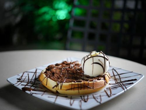 a doughnut with chocolate and marshmallow on a plate at Marelia Hotel in Poligiros
