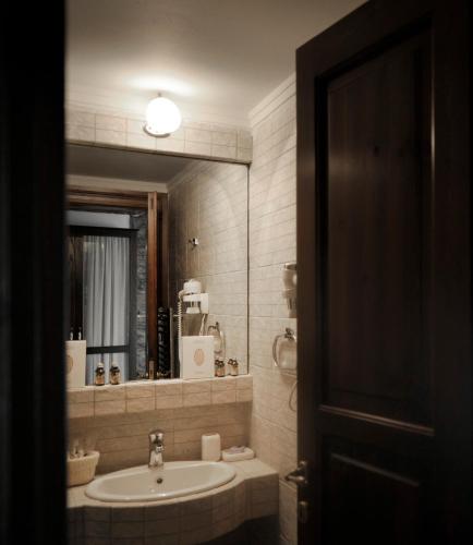 a bathroom with a sink and a mirror at Marelia Hotel in Poligiros