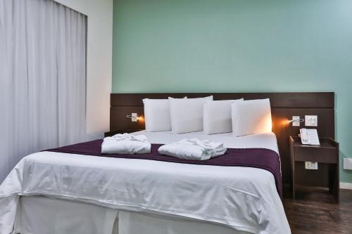 Krevet ili kreveti u jedinici u objektu San Diego Suites Pampulha Hotel - Oficial